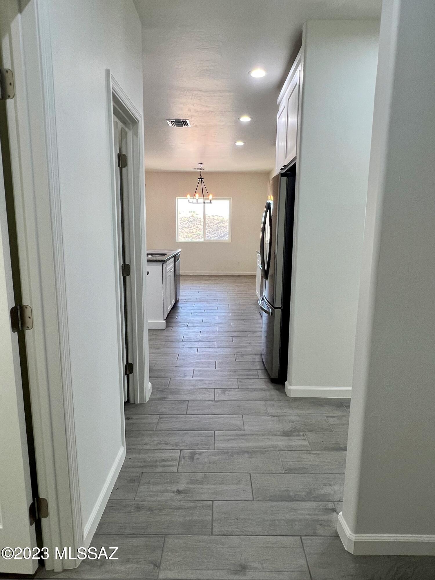353 Dock Street Rio Rico, AZ 85648 - Photo 13 of 50 a view of a hallway with wooden shelves