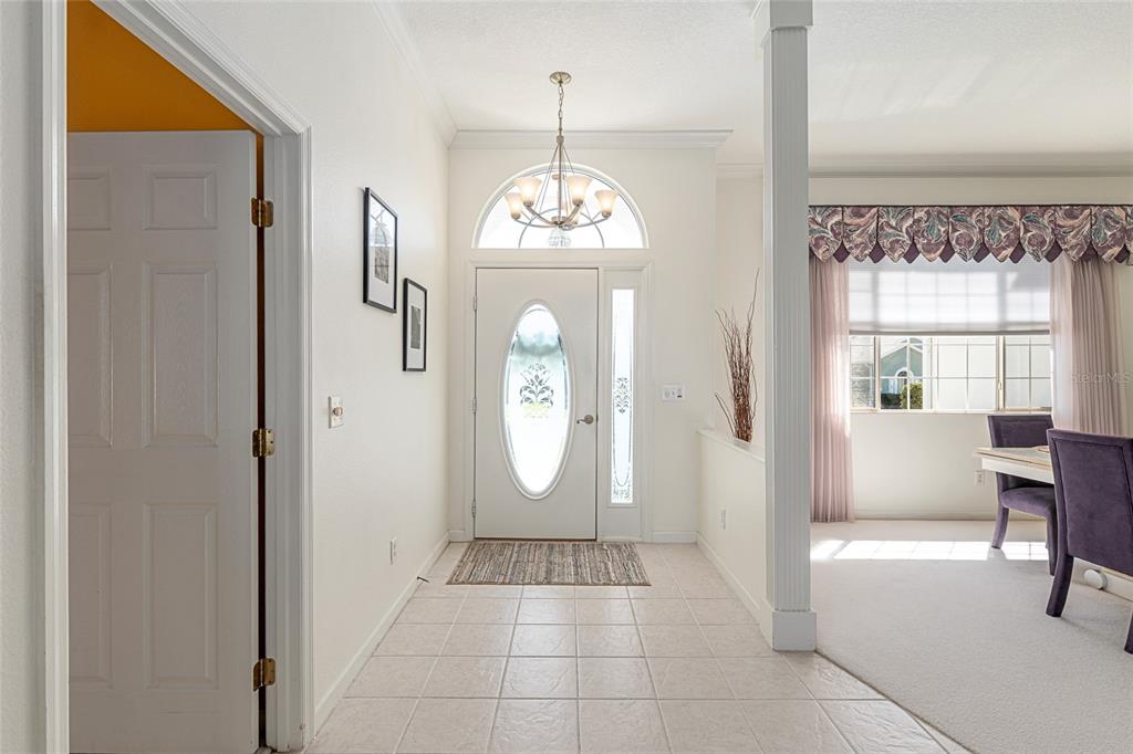 5711 Northwest 25th Loop Ocala, FL 34482 - Photo 13 of 91 a view of a hallway with windows chandelier and chandelier
