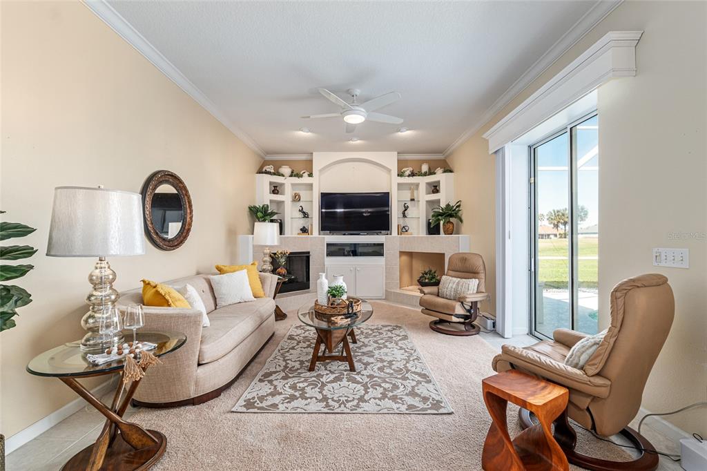 5711 Northwest 25th Loop Ocala, FL 34482 - Photo 22 of 91 a living room with furniture a flat screen tv and a large window