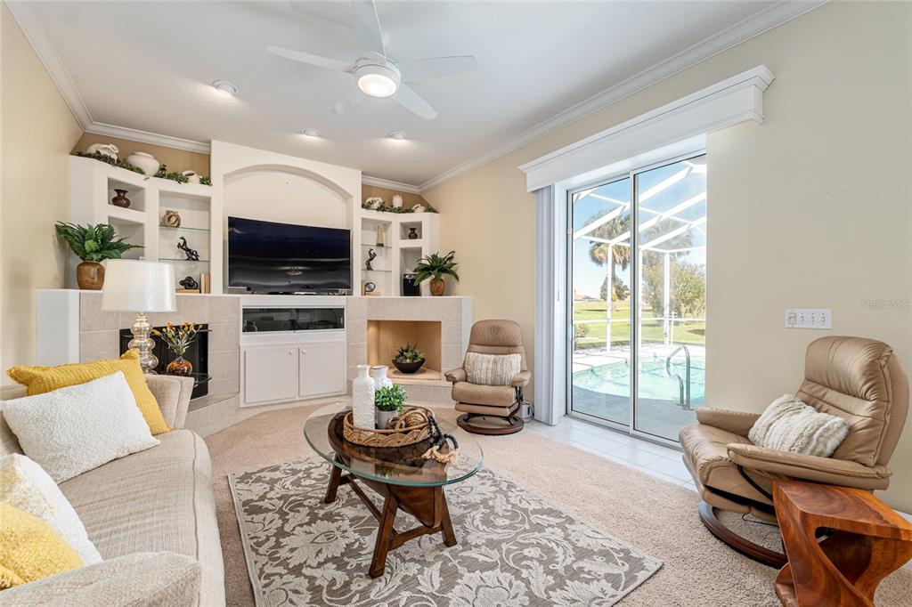 5711 Northwest 25th Loop Ocala, FL 34482 - Photo 23 of 91 a living room with furniture a flat screen tv and a large window