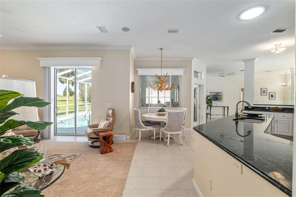5711 Northwest 25th Loop Ocala, FL 34482 - Photo 27 of 91 a large living room with stainless steel appliances granite countertop furniture and a large window