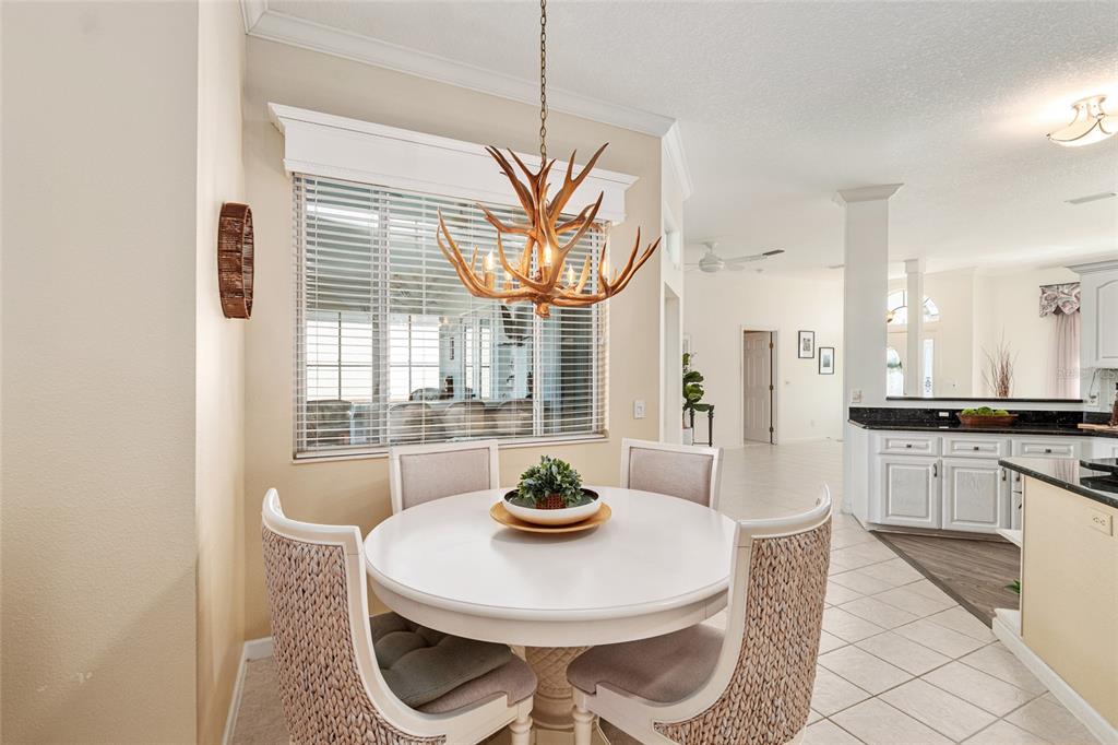 5711 Northwest 25th Loop Ocala, FL 34482 - Photo 28 of 91 a kitchen with stainless steel appliances a dining table and a refrigerator