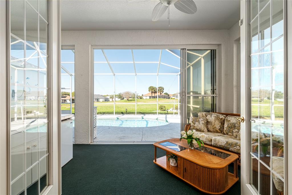 5711 Northwest 25th Loop Ocala, FL 34482 - Photo 43 of 91 a living room with patio furniture and a floor to ceiling window