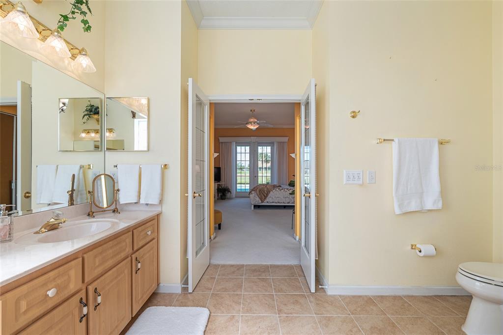 5711 Northwest 25th Loop Ocala, FL 34482 - Photo 51 of 91 a en suite bathroom with a sink a mirror and a toilet