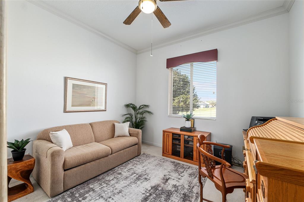 5711 Northwest 25th Loop Ocala, FL 34482 - Photo 52 of 91 a living room with furniture a window and a bookshelf