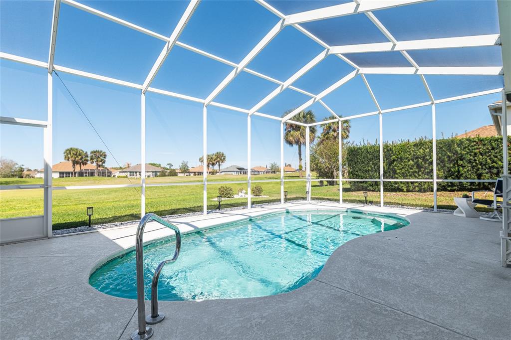 5711 Northwest 25th Loop Ocala, FL 34482 - Photo 69 of 91 a view of a swimming pool with lawn chairs and a yard