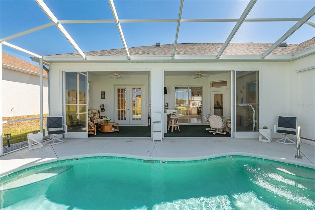 5711 Northwest 25th Loop Ocala, FL 34482 - Photo 71 of 91 a view of a patio with table and chairs under an umbrella