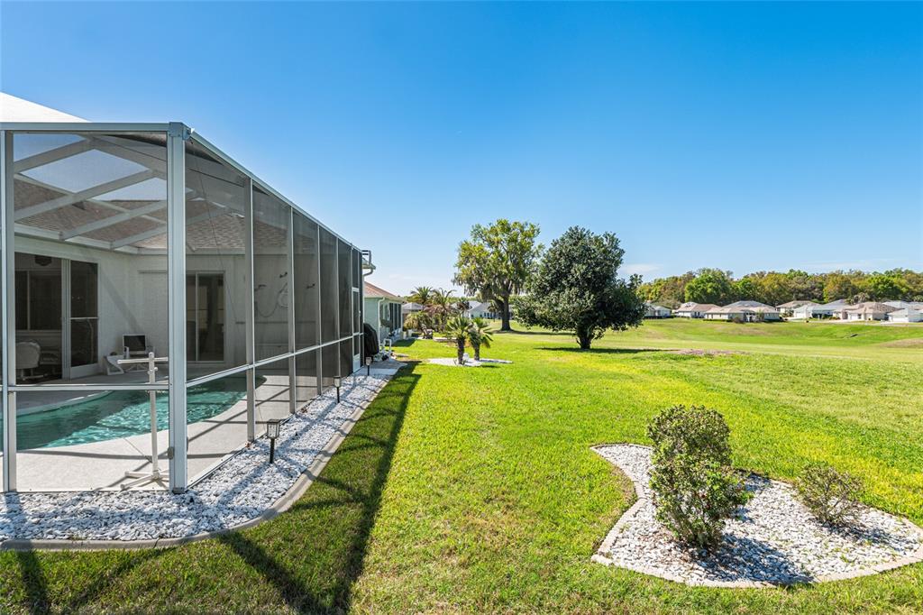 5711 Northwest 25th Loop Ocala, FL 34482 - Photo 77 of 91 a swimming pool with outdoor seating and garden