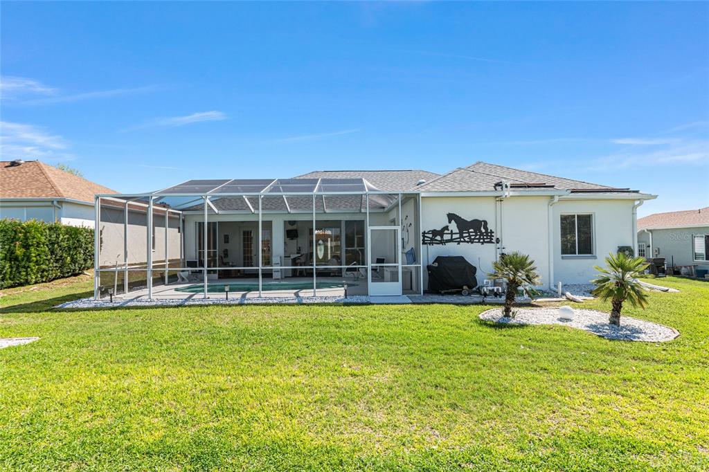 5711 Northwest 25th Loop Ocala, FL 34482 - Photo 79 of 91 a view of a house with a backyard porch and sitting area