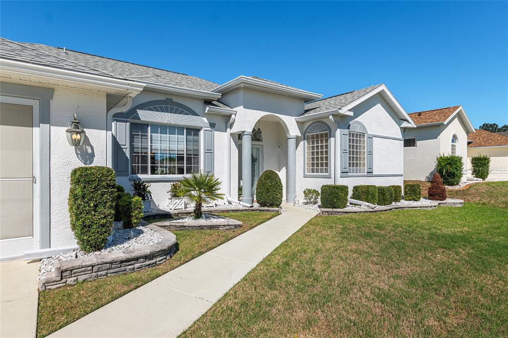 5711 Northwest 25th Loop Ocala, FL 34482 - Photo 9 of 91 a front view of a house with garden and plants
