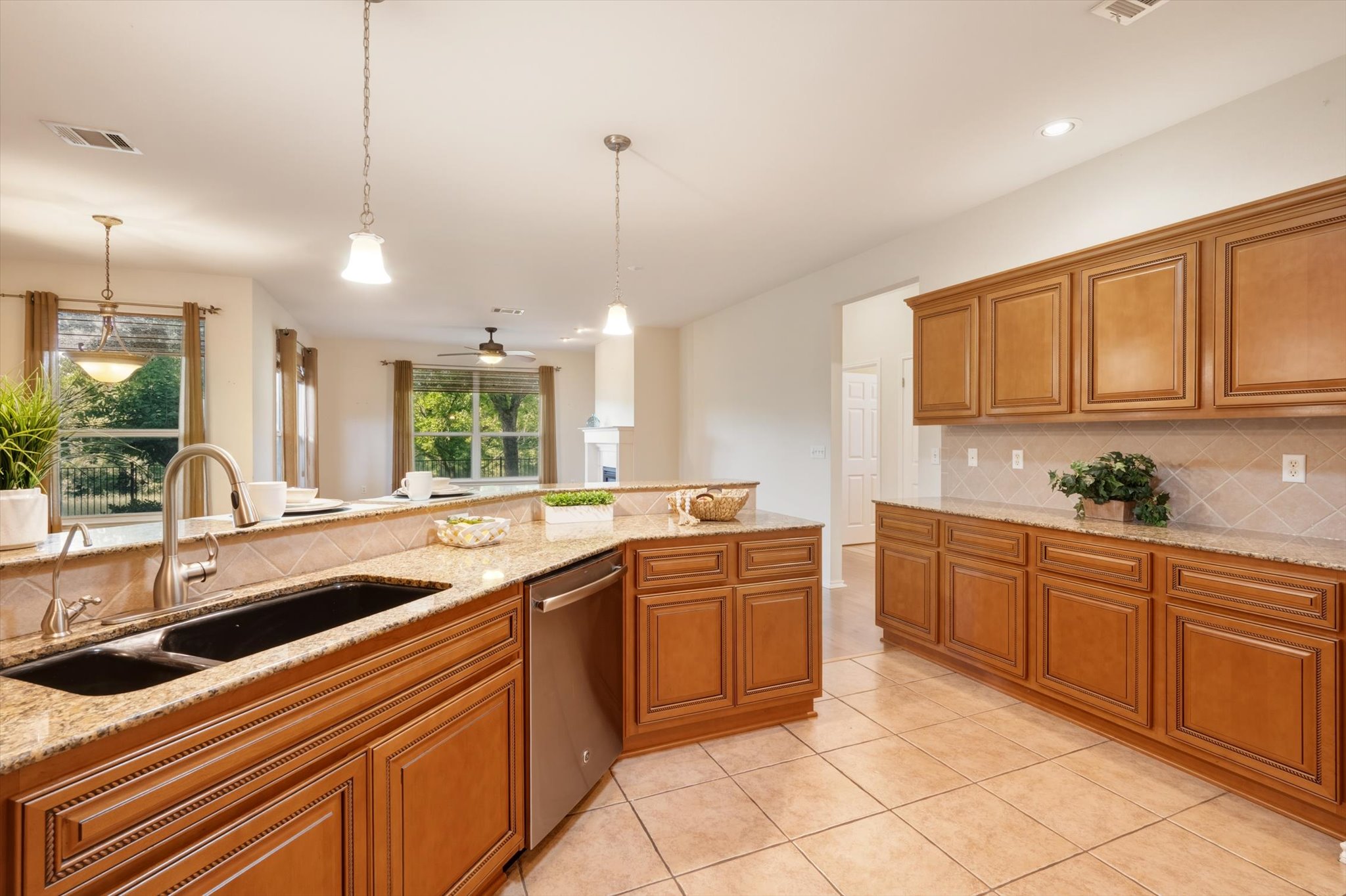 126 Trail Rider Way Georgetown, TX 78633 - Photo 14 of 30 a kitchen with lots of counter top space sink and stainless steel appliances