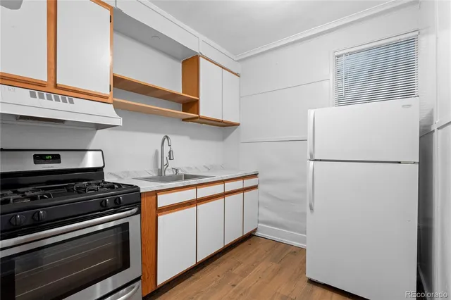 a kitchen with stainless steel appliances a refrigerator and a stove
