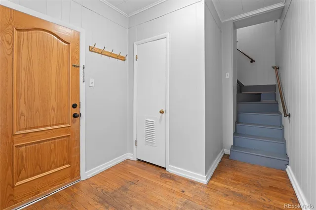 a view of an entryway with wooden floor