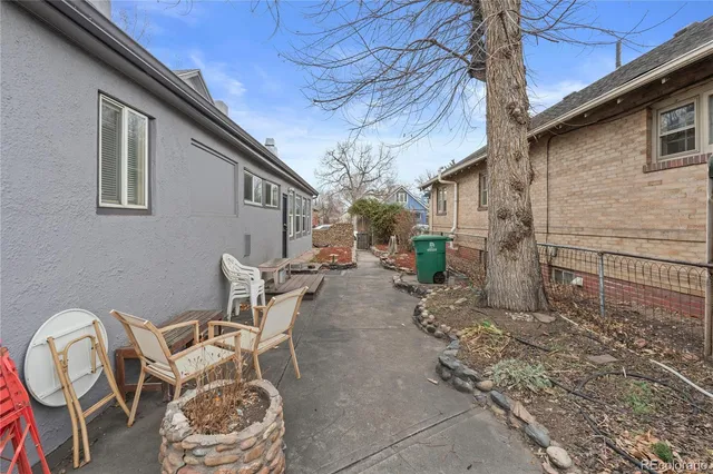 a backyard of a house with table and chairs