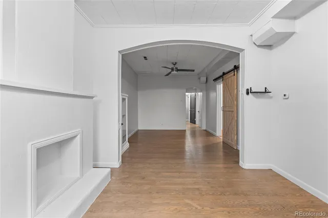 a view of a hallway view with wooden floor and staircase