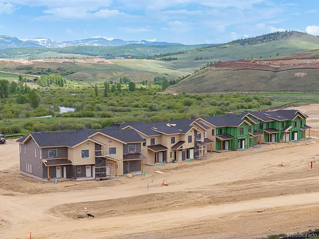 an aerial view of residential houses and outdoor space