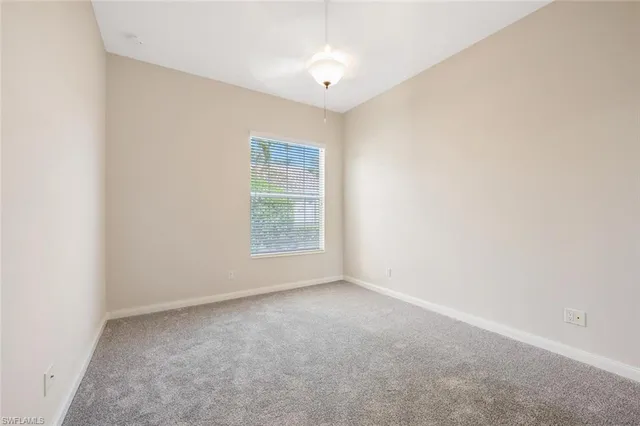 a view of empty room with wooden floor and windows