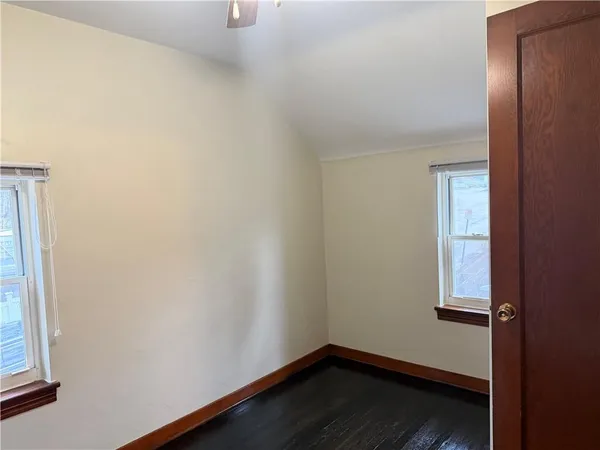 a small space with wooden floor and a window