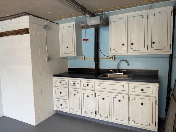 a kitchen with white cabinets and a sink
