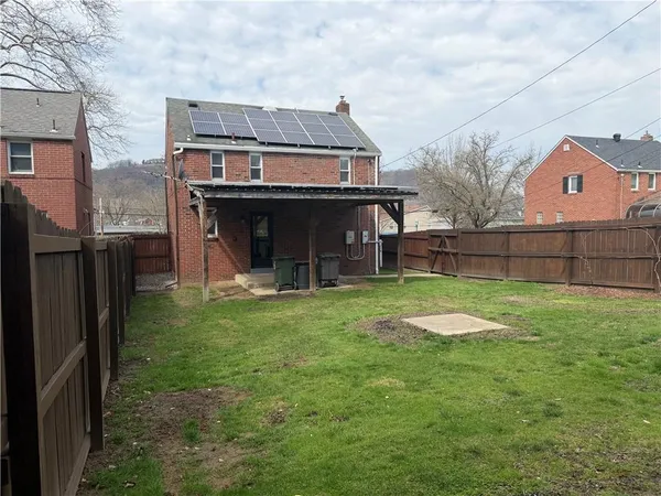 a backyard of a house with barbeque oven table and chairs