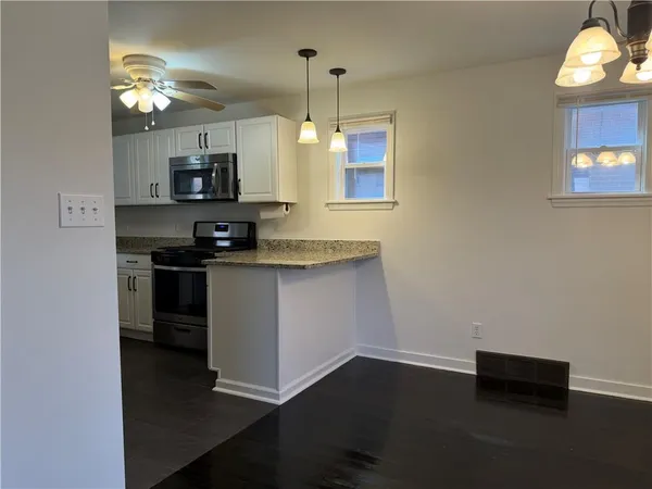 a kitchen with a microwave and a sink
