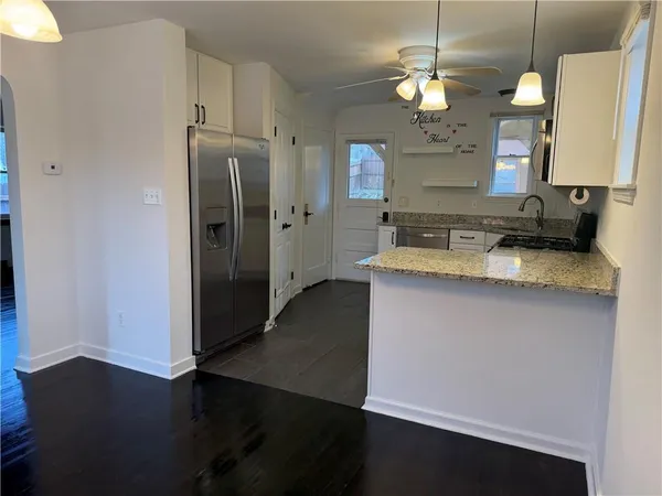 a kitchen with a refrigerator and a sink