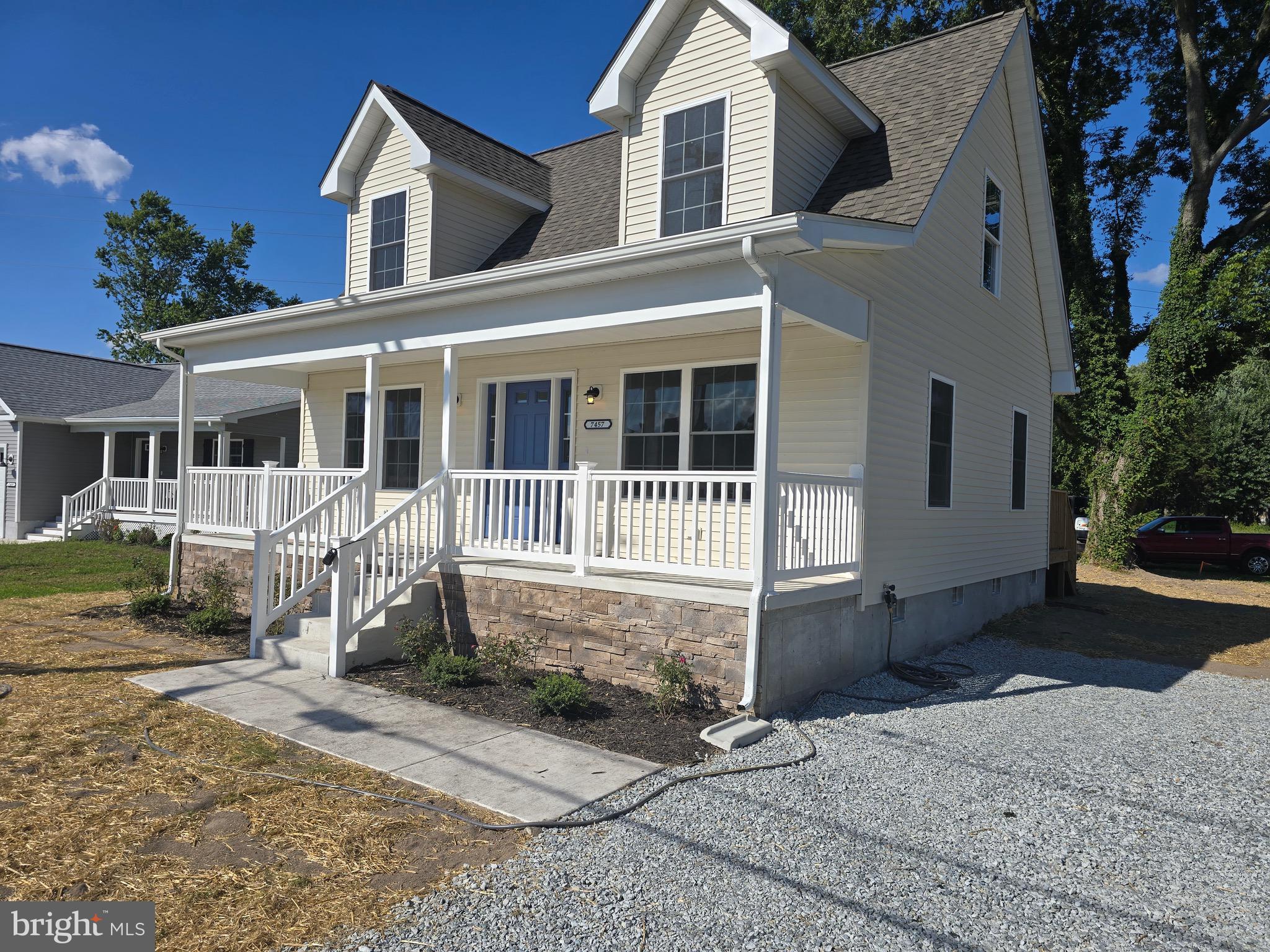 7457 Market Street Willards, MD 21874 - Photo 12 of 51 a front view of a house with a yard