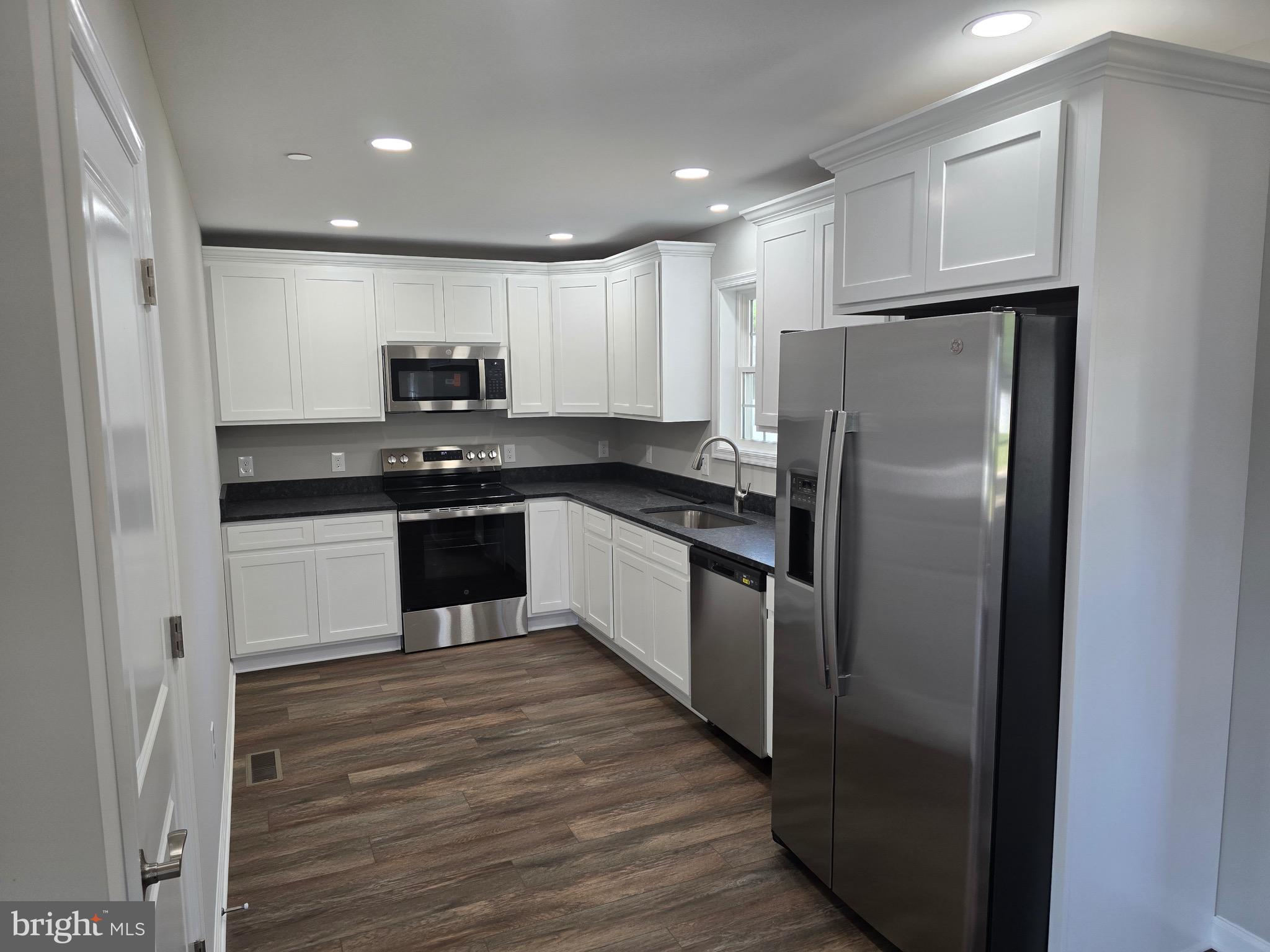 7457 Market Street Willards, MD 21874 - Photo 19 of 51 a kitchen with stainless steel appliances granite countertop a stove a refrigerator and a sink