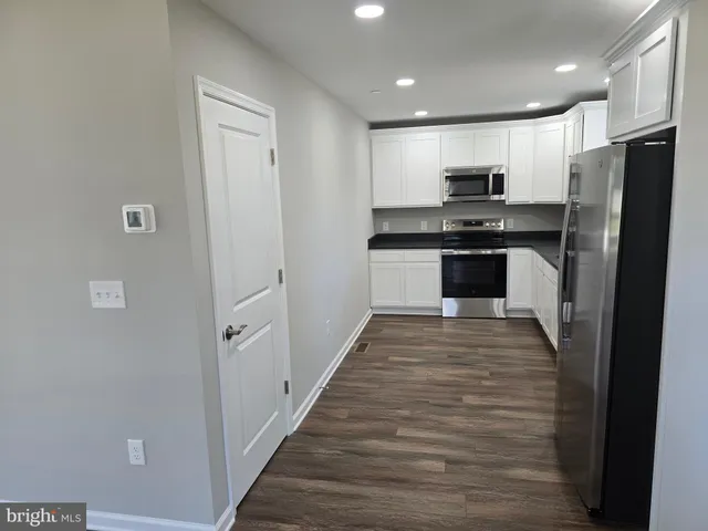 a kitchen with stainless steel appliances a refrigerator and a sink