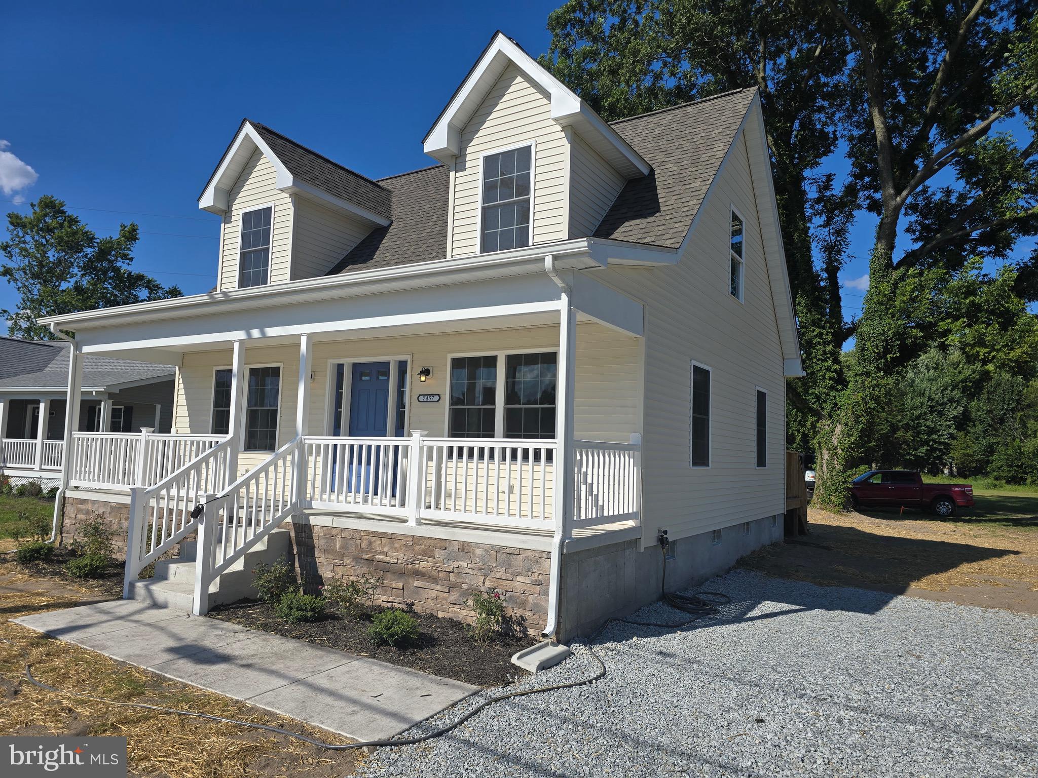7457 Market Street Willards, MD 21874 - Photo 2 of 51 a front view of a house with a yard