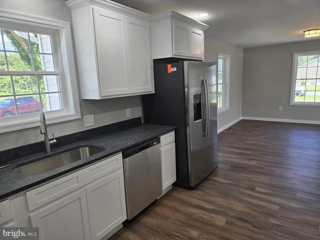 a kitchen with a refrigerator and a sink