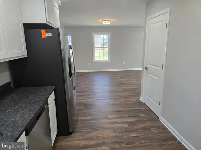 a view of a kitchen cabinets and wooden floor