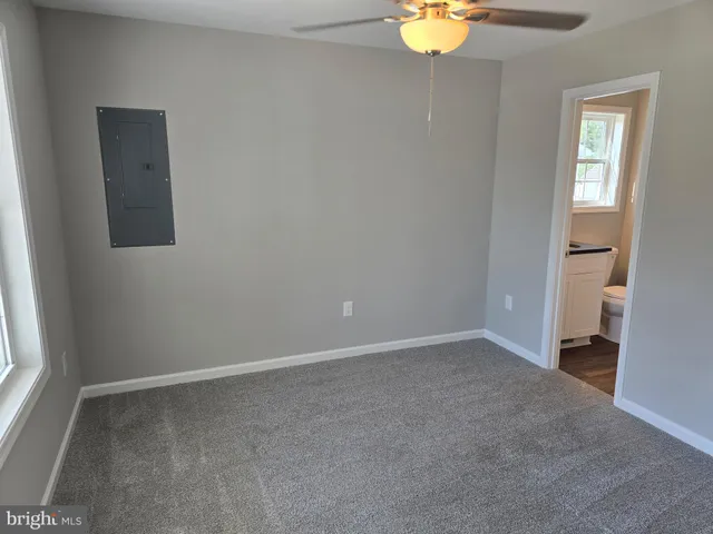 an empty room with a window and closet