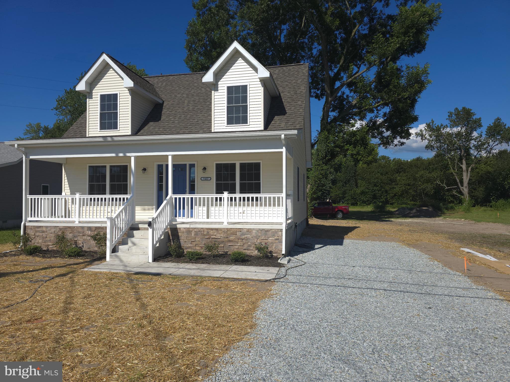 7457 Market Street Willards, MD 21874 - Photo 30 of 51 a front view of a house with a yard and garage