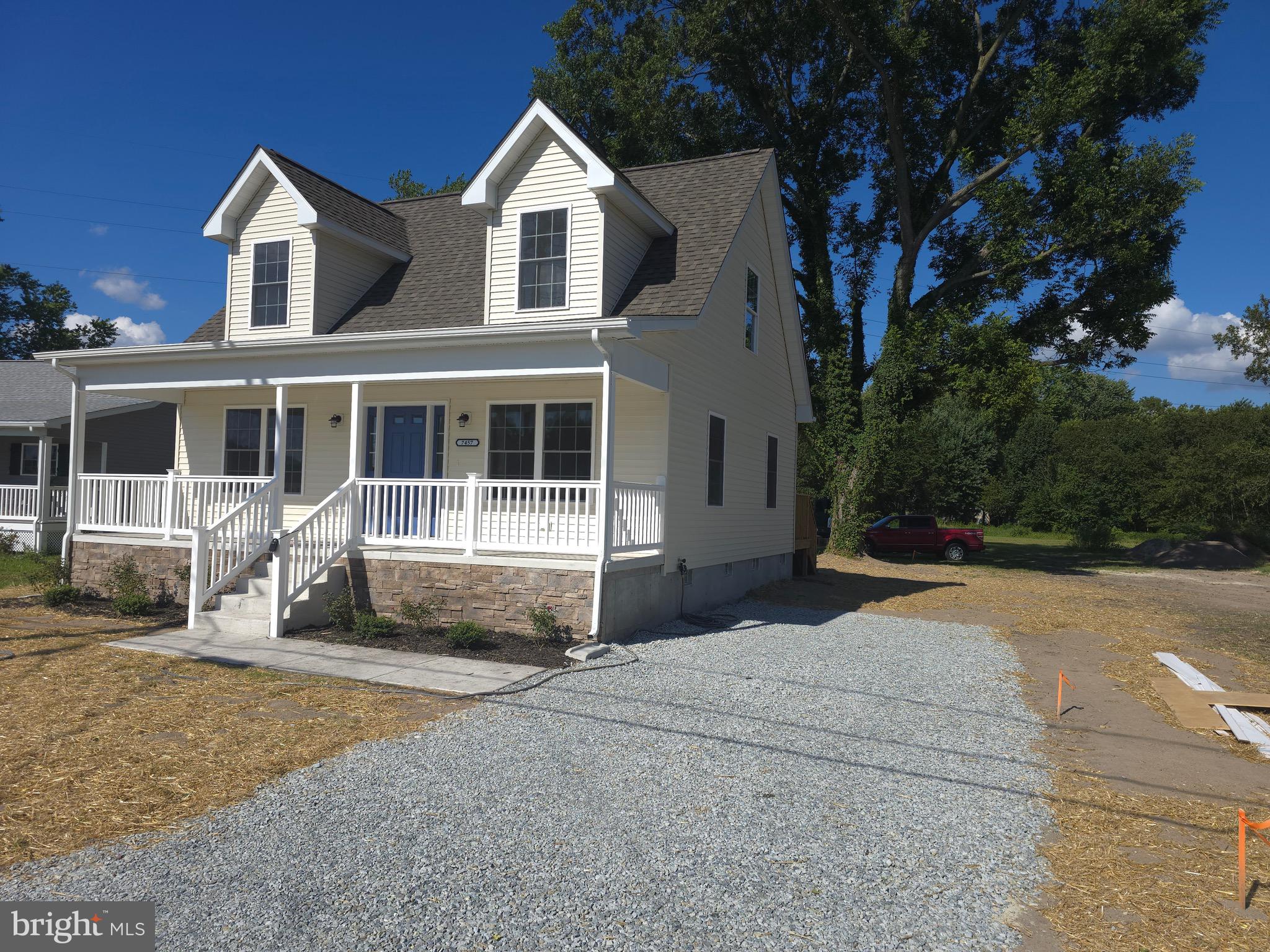 7457 Market Street Willards, MD 21874 - Photo 47 of 51 a front view of a house with a yard and garage