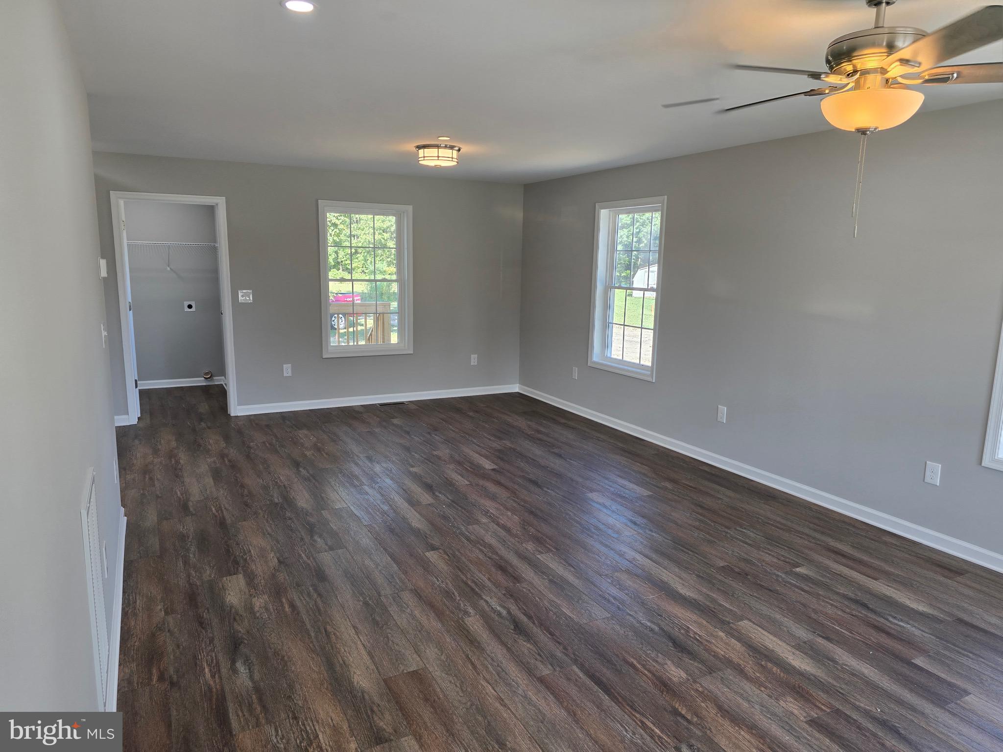 7457 Market Street Willards, MD 21874 - Photo 9 of 51 a view of an empty room with wooden floor and a window