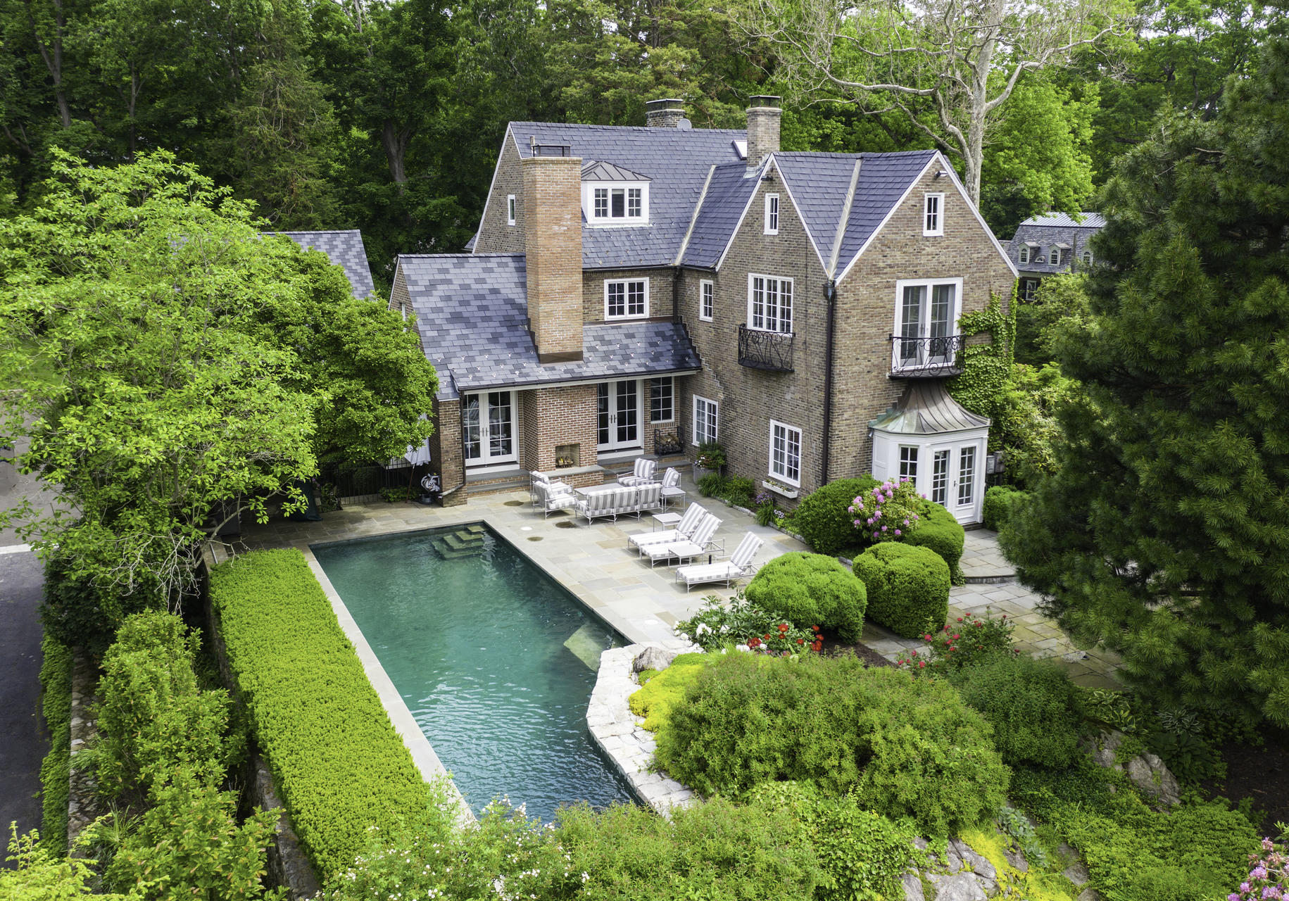 a aerial view of a house with swimming pool garden and patio