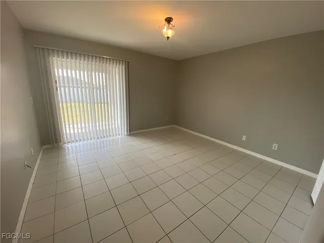 a view of an empty room with floor to ceiling windows