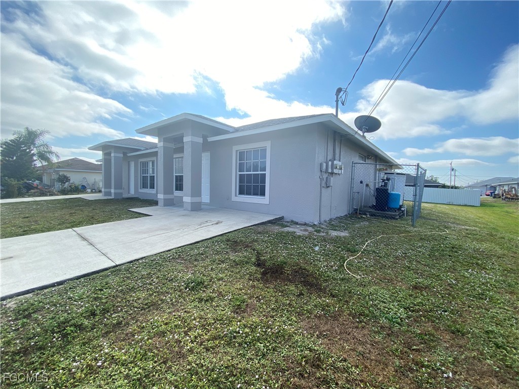 4543 20th Street Southwest Lehigh Acres, FL 33973 - Photo 18 of 19 a view of a house with a yard