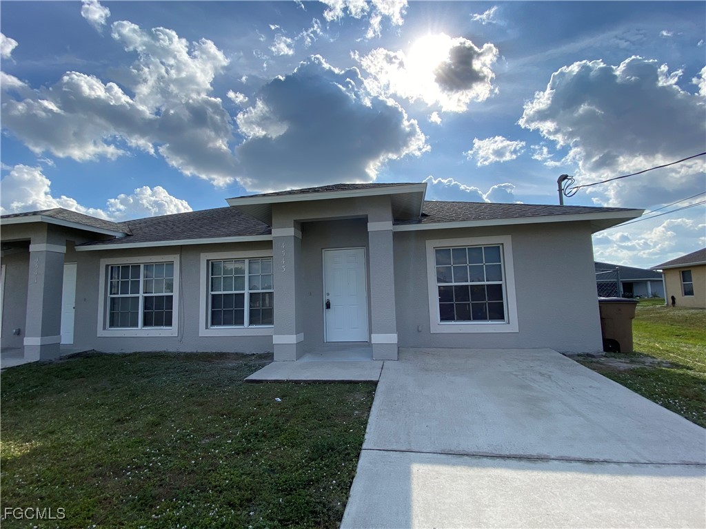 4543 20th Street Southwest Lehigh Acres, FL 33973 - Photo 2 of 19 front view of a house with a yard