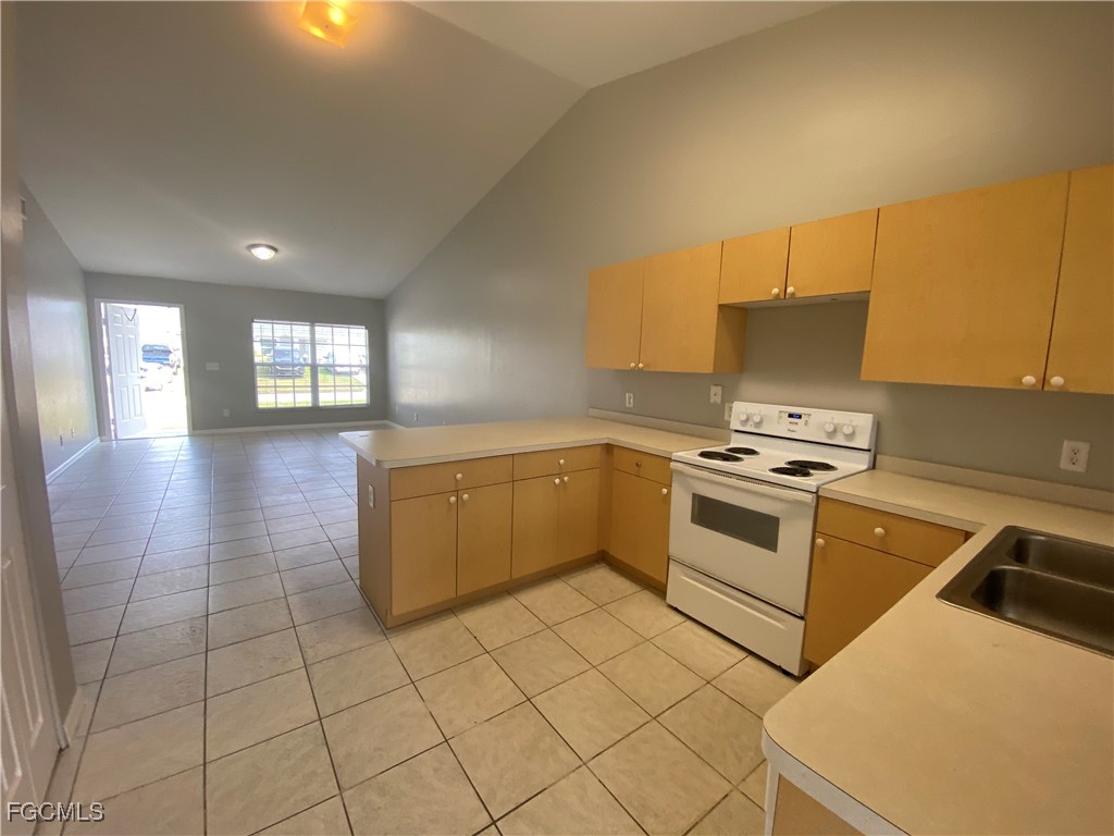 4543 20th Street Southwest Lehigh Acres, FL 33973 - Photo 7 of 19 a kitchen with a cabinets and appliances