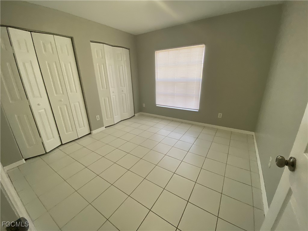 4543 20th Street Southwest Lehigh Acres, FL 33973 - Photo 9 of 19 an empty room with windows