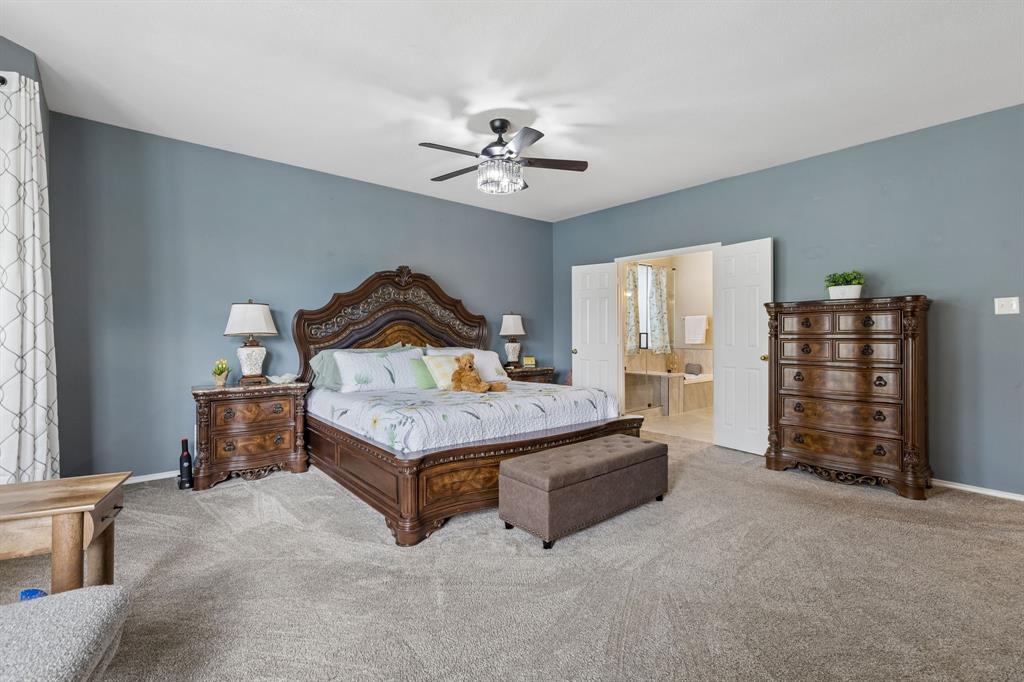 129 Timberbluff Lane Murphy, TX 75094 - Photo 17 of 34 a bedroom with a bed chandelier and a window