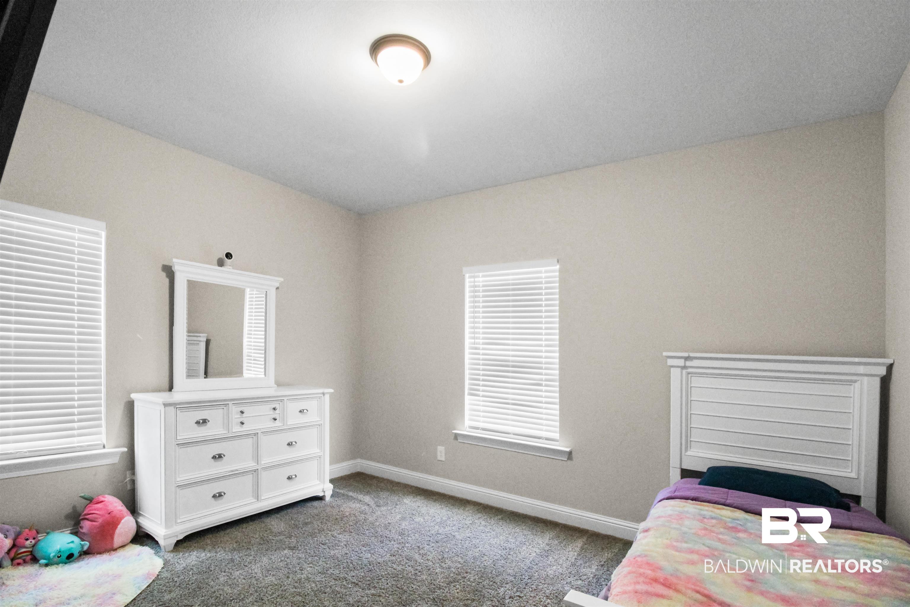 26197 Eagle Trace Elberta, AL 36530 - Photo 21 of 26 Bedroom featuring carpet flooring and multiple windows