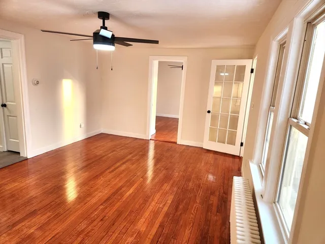 wooden floor in an empty room with a window