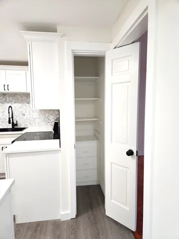 a utility room with cabinets washer and dryer