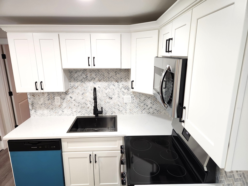 41 Bridgeport Street Worcester, MA 01604 - Photo 20 of 37 a kitchen with a stove and a refrigerator