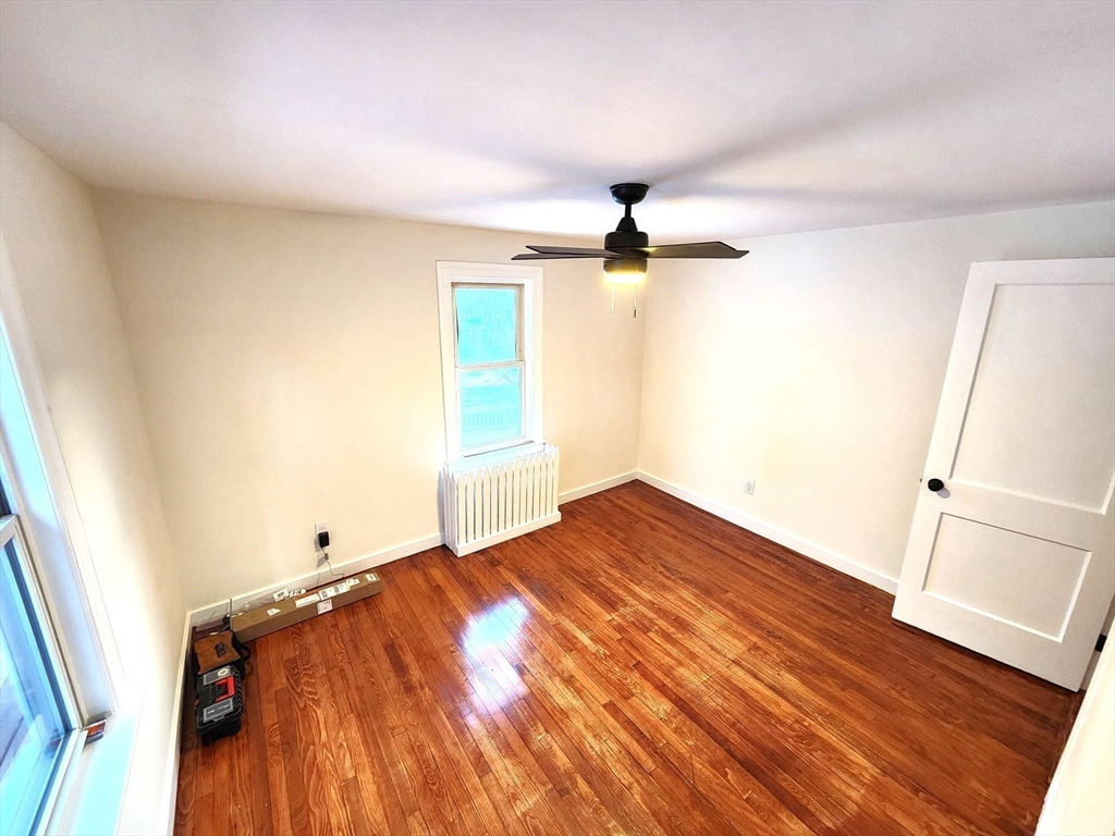 41 Bridgeport Street Worcester, MA 01604 - Photo 24 of 37 an empty room with wooden floor and windows