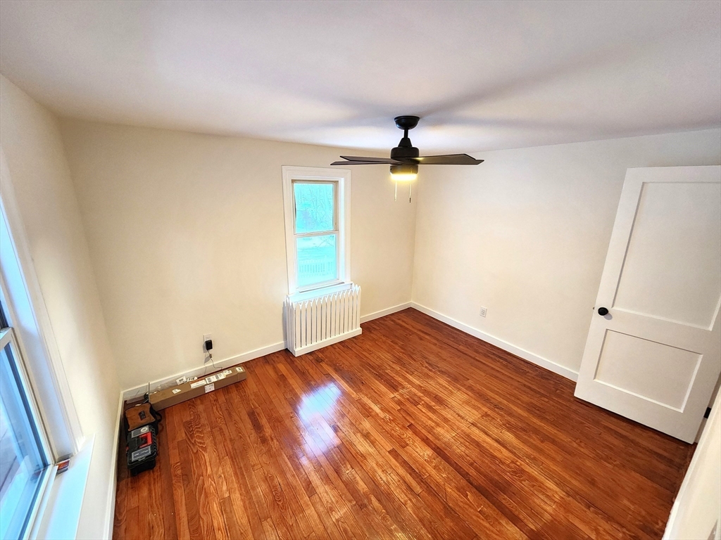 41 Bridgeport Street Worcester, MA 01604 - Photo 26 of 37 an empty room with wooden floor fan and windows
