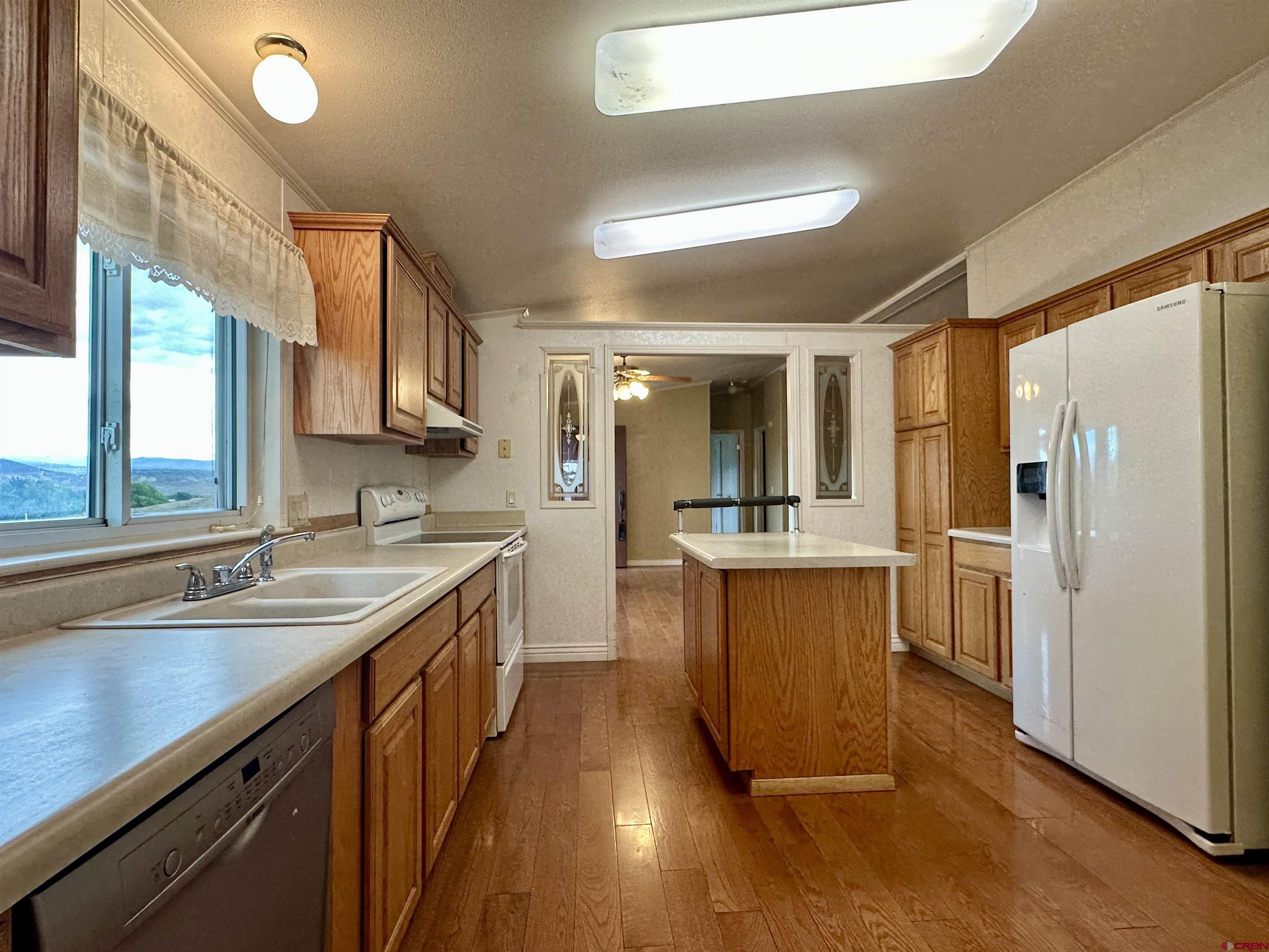 9427 2100th Road Austin, CO 81410 - Photo 15 of 42 a kitchen with a sink stove and refrigerator